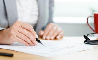 Woman signing a letter